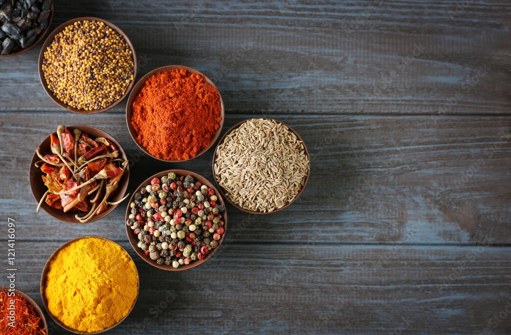Different spices in bowls on table