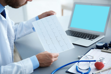 Wall Mural - Male doctor at work in clinic office