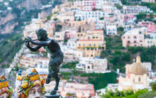 It Is Said That The Satyrs Were Great Flute Players Who Enthralled With Their Music . Millions Of Tourists Are Enchanted By His Music , Or By The Beauty Of Positano?