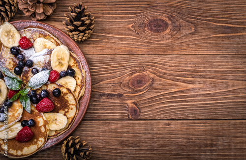 Fotografie, Obraz Pancakes with fresh fruit for breakfast, top view.
