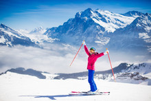 Young Woman Skiing In The Mountains.