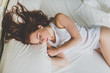 © ADDICTIVE STOCK - Beautiful woman sleeping on white bed