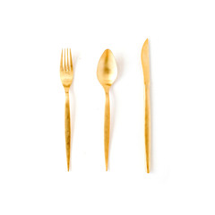 Wall Mural - golden fork, spoon, knife isolated on white. flat lay, top view