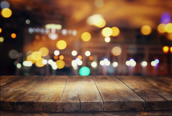 wooden table in front of abstract blurred restaurant lights