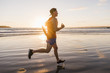 © Westend61 - France, Crozon peninsula, jogger on the beach at sunset