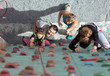 Little baby girl doing first steps on climbing wall