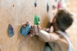© alexbrylovhk - Young Female Climber on wall of indoor climbing gym