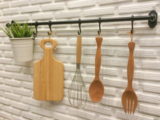 Kitchenware hanging on brick wall.