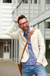 © mimagephotos - Attractive middle aged guy standing outdoors and laughing
