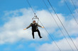 © aquatarkus - Man in formal suit descends on a zipline
