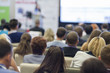 © danmorgan12 - Female Host Speaking in Front of the Large Audience During Business Conference