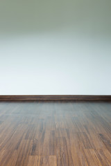 empty room interior, brown wood laminate floor and white mortar