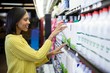 Woman buying milk from dairy section