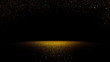 Leinwandbild Motiv twinkling golden glitter falling on a flat surface lit by a bright spotlight

