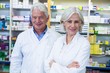 © WavebreakMediaMicro - Smiling pharmacists standing in pharmacy