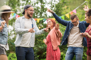 Sticker - happy friends dancing at summer party in garden