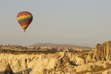 Fototapeta Góry - Hot air balloon flying over rock landscape at Cappadocia Turkey