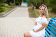 © freshstockplace - Beautiful lovely girl wearing her first child in the stomach and is looking forward to his birth. Strolling in the park, enjoy nature and quietness