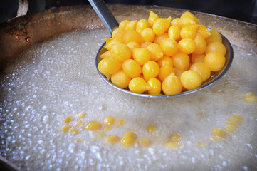 Thong Yod or Gold Egg Yolks Drops (Thai traditional dessert) boiled in sugar syrup. Made of egg yolk, sugar and flour look like dropping of water