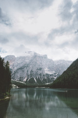 Braies lake with green water and mountains with trees