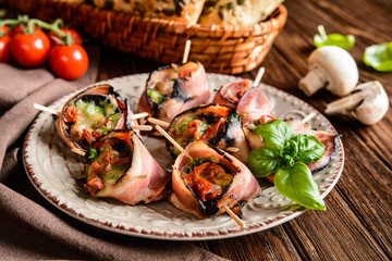 Wall Mural - Bacon wrapped mushrooms stuffed with mozzarella, sun dried tomatoes and herbs