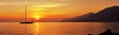 canvas print picture - Panoramic view of Sailing at sunset with mountains