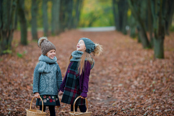 Little adorable girls outdoors at warm sunny autumn day