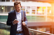 © Production Perig - Young attractive business man using smartphone