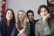 © PhotoAlto - Friends sitting together and watching movie at home