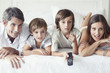 © PhotoAlto - Family watching television together in bedroom