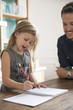 © PhotoAlto - Father watching young daugther practice writing