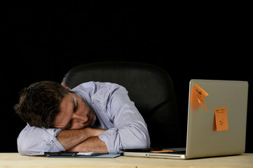  businessman sleeping wasted and tired at office computer desk in long hours of work