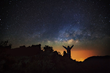 Wall Mural - landscape with milky way, night sky with stars and silhouette of
