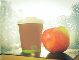 Wall Mural - Coffee cup against window with rainy day view