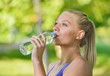 © FS-Stock - Senior athletic woman drinks water from a bottle after running