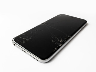 Wall Mural - Close up image of broken smartphone with cracked screen isolate on white. Shallow DOF.
