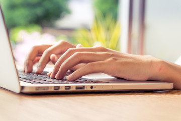 Put fingers on the keyboard of labtop with vintage style.