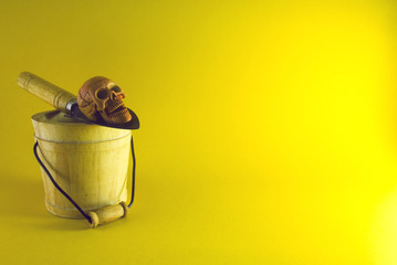 shovel with skull on wood bucket