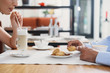 © Yakobchuk Olena - Man and woman having lunch at cafe
