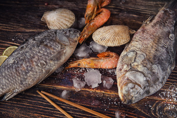 Food wooden background with Seafood, sticks, lime, salt. Copy sp