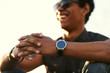 © kegfire - young Man wearing round smartwatch.