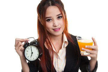 Wall Mural - Asian woman with a clock drink orange juice.