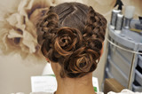 Beautiful wedding hairstyle. The bride's hairstyle in the beauty salon. Rear view.