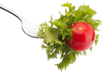 fresh salad and cherry tomato on fork isolated on white backgrou