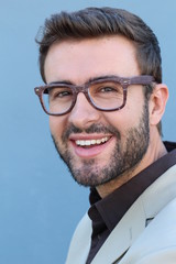 Wall Mural - Young handsome man with great smile wearing fashion eyeglasses against neutral background with lots of copy space