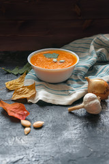 Canvas Print - Vegan healthy pumpkin soup puree on dark slate table. Vertical photo.