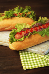 Wall Mural - Delicious hot dogs on wooden board