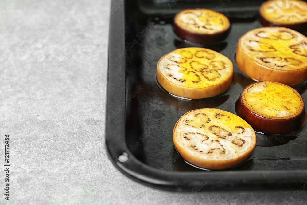 Sliced eggplant on baking tray, closeup