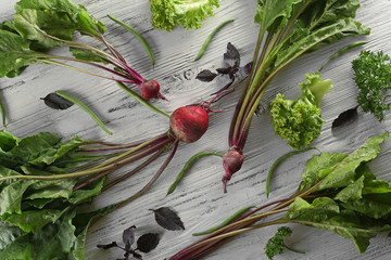 Wall Mural - Young beets on light wooden background