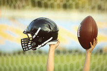 Male Hands Holding Rugby Helmet And Ball